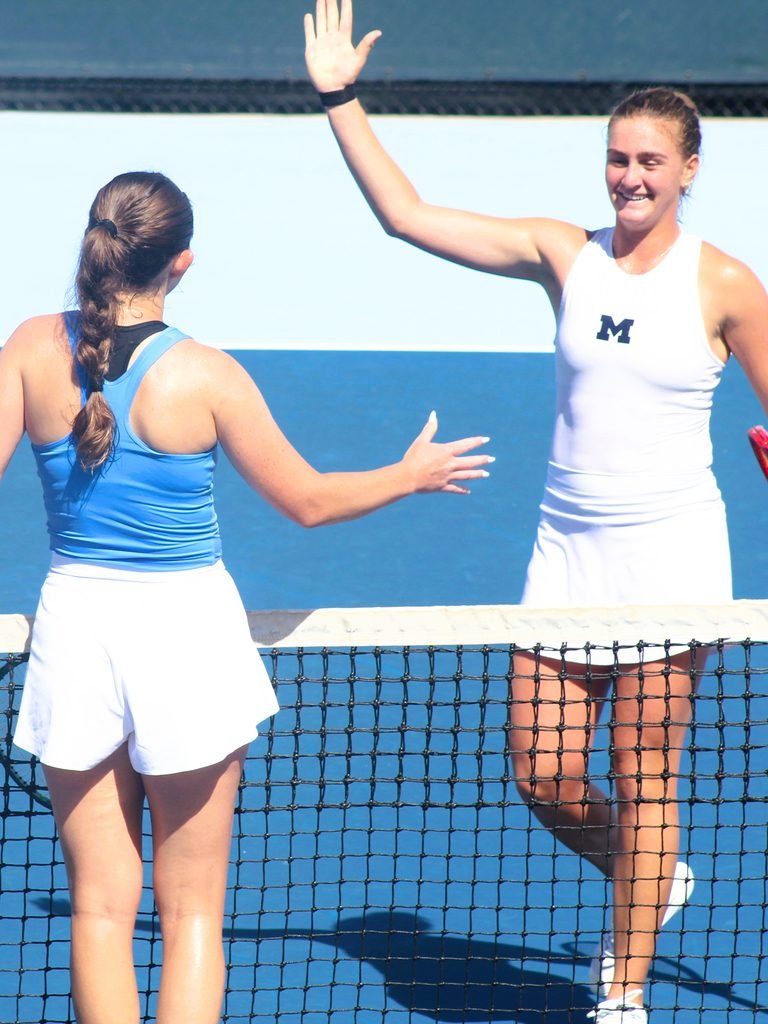 No. 6 Piper Charney and No. 95 Nicole Khirin meet at net after match at Kitty Harrison Invitational.