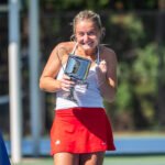 Luciana Perry holds ITA All Americans singles trophy