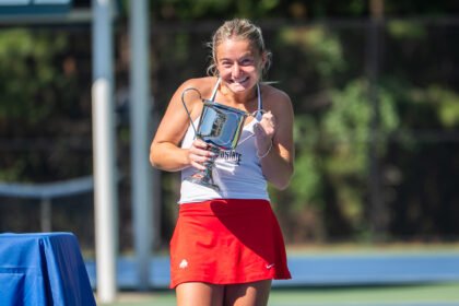Luciana Perry holds ITA All Americans singles trophy